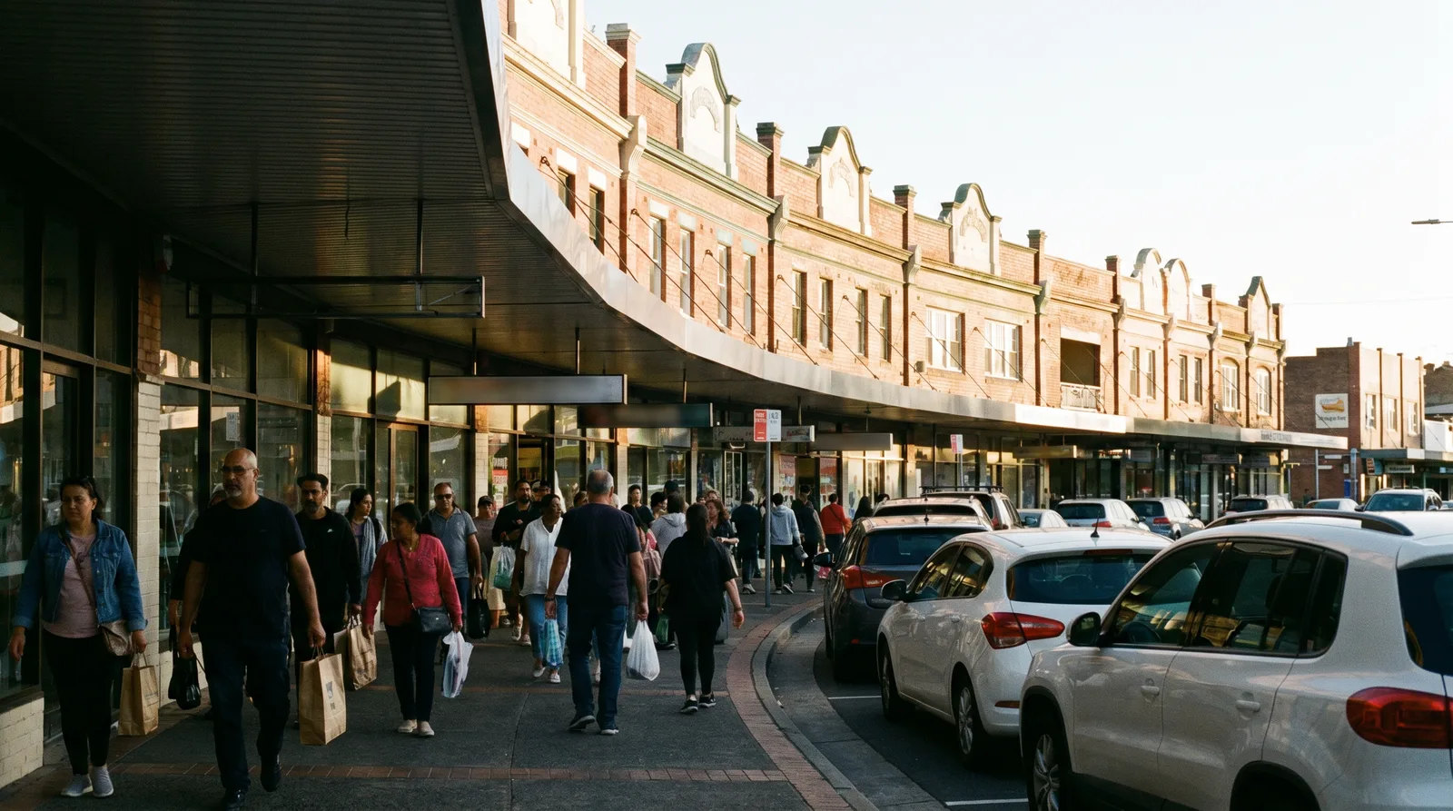 The curved shop strip on The Crescent, Fairfield, on a busy morning
